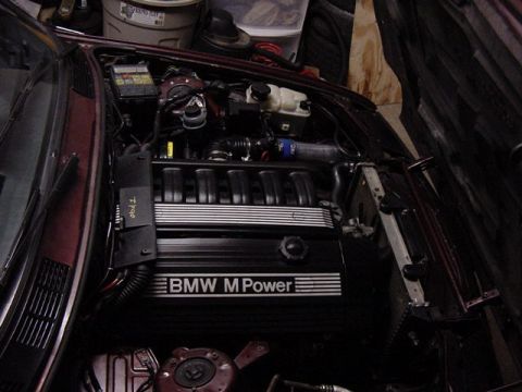1984 BMW 3 Series - Engine bay of a BMW M Power vehicle, showing the engine cover and surrounding components.
