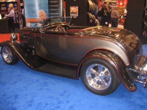 1998 Ford Crown Victoria - A custom hot rod with a two-tone paint job and chrome wheels is displayed on a blue carpet.