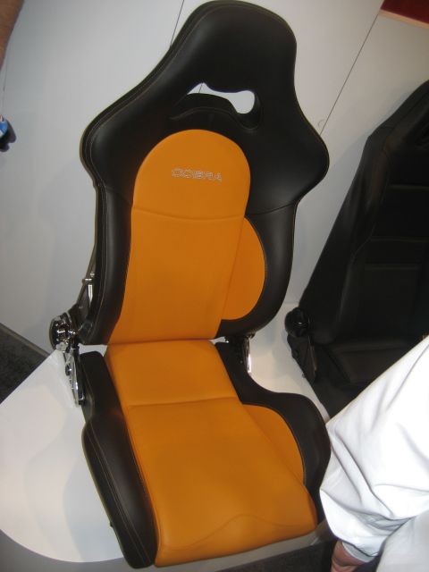 1998 Ford Crown Victoria - A racing seat with orange and black upholstery features the 'Cobra' brand name embroidered on the headrest.