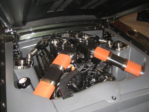 1998 Ford Crown Victoria - Custom engine bay with chrome accents and orange intake hoses, showing Roush branding on the engine block.