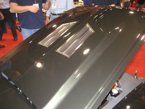 1998 Ford Crown Victoria - Close-up of a car hood showing two vents with chrome trim.