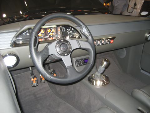 1998 Ford Crown Victoria - The interior of a car shows a custom steering wheel and a unique gear shifter.