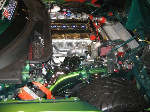 1998 Ford Crown Victoria - Customized engine bay a turbocharged V8 with GM valve covers and a BFGoodrich sticker.