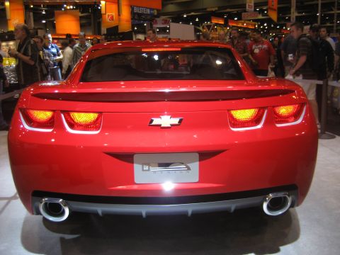 1998 Ford Crown Victoria - Rear view of a red Chevrolet Camaro with distinctive taillights and a Chevrolet emblem.