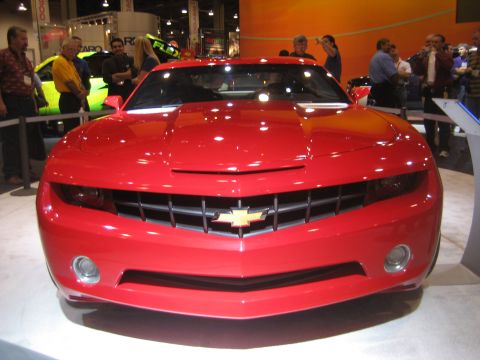 1998 Ford Crown Victoria - Front view of a red Chevrolet Camaro at an auto show.