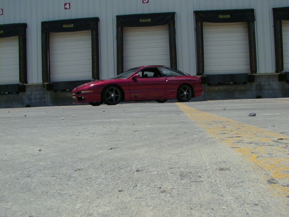 Red coupe parked in front of loading docks