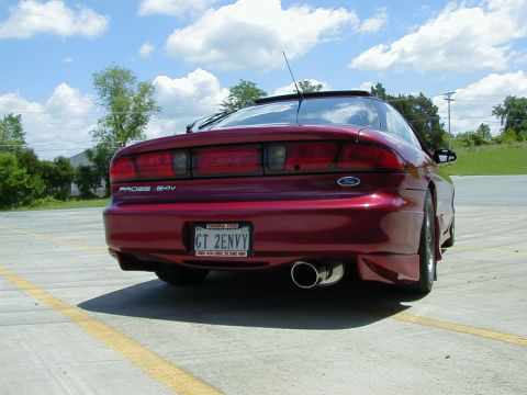 1994 Ford Probe - Rear view of a red 1994 Ford Probe GT 24v, a custom license plate and dual exhaust.