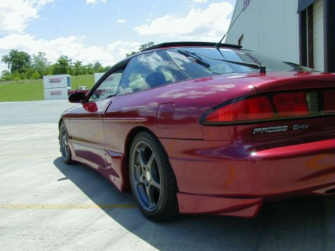 1994 Ford Probe - Rear quarter view of a red 1994 Ford Probe 24V, showing its distinctive body style and taillights.