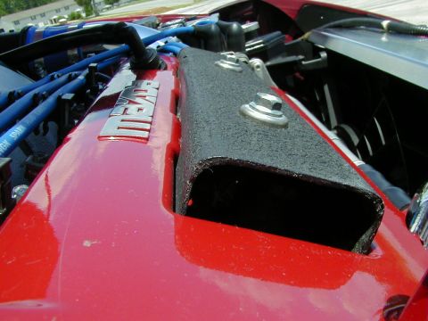 1994 Ford Probe - Close-up view of a red engine valve cover with a "MAZDA" badge and blue spark plug wires.