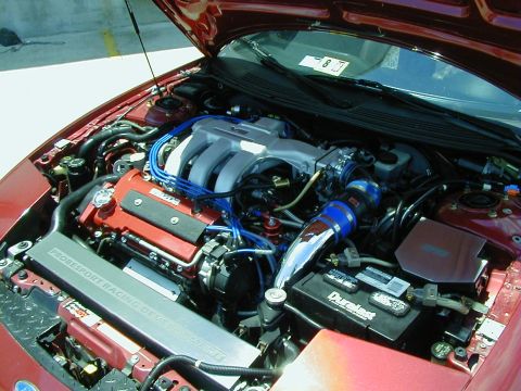 1994 Ford Probe - Engine bay of a car, showing the V6 engine and various aftermarket parts.