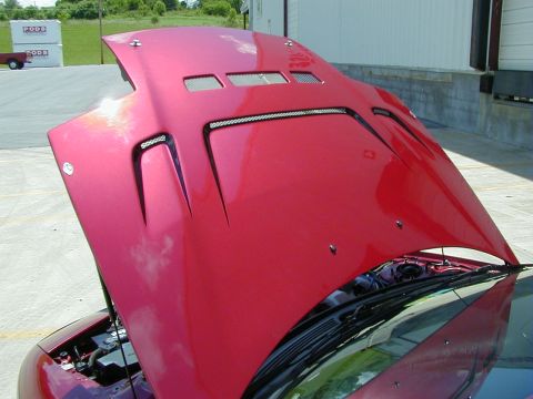 1994 Ford Probe - The custom red hood of a car is open, revealing vents and LED light strips, with the engine compartment visible below.