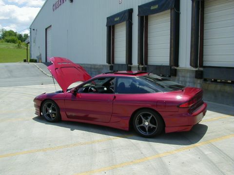 1994 Ford Probe - Red 1994 Ford Probe coupe with hood open parked outside a warehouse.