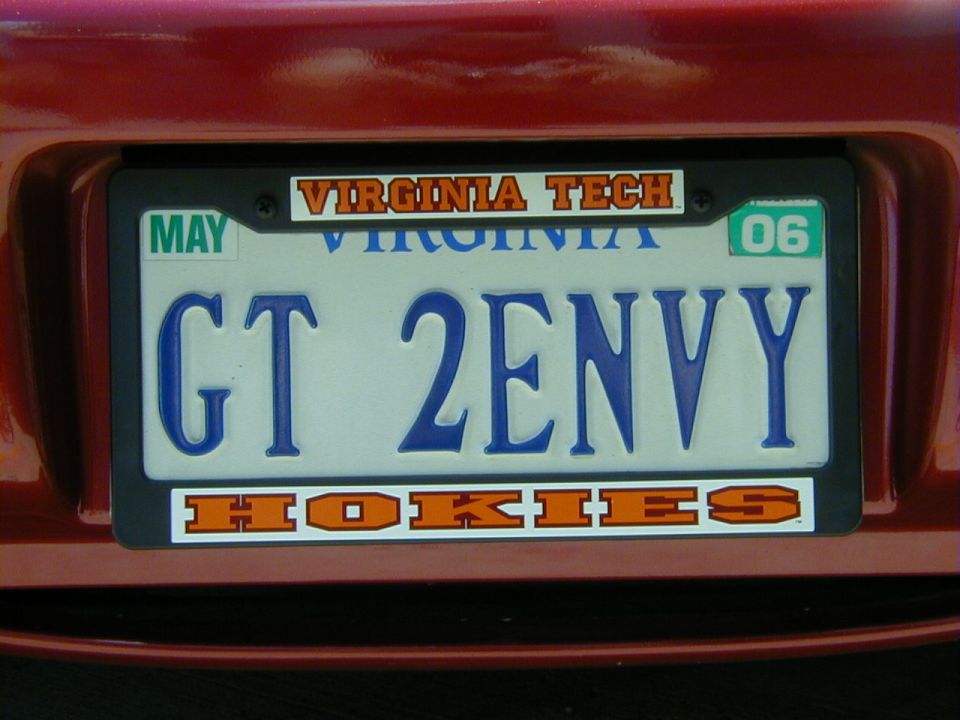 Red car rear bumper with Virginia license plate reading GT 2ENVY, "Virginia Tech" and "Hokies" stickers