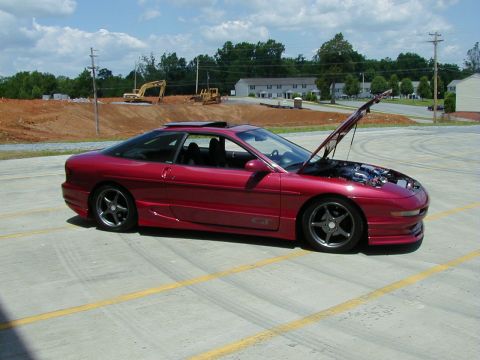 1994 Ford Probe - Red 1994 Ford Probe GT parked on asphalt with hood open, construction site in background.