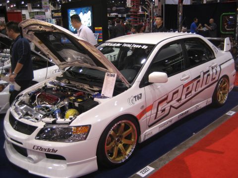 1998 Ford Crown Victoria - This modified Mitsubishi Lancer Evolution is displayed with its hood open, revealing the engine bay.