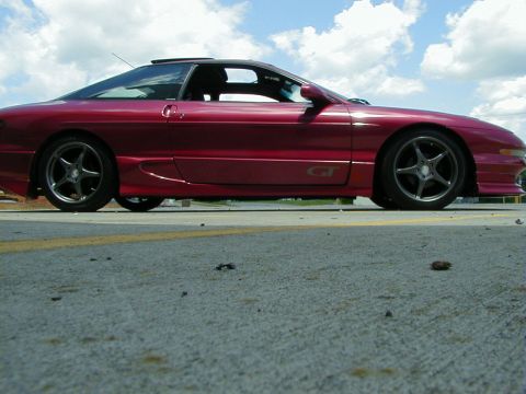 1994 Ford Probe - This 1994 Ford Probe GT is shown in a side profile against a cloudy sky.