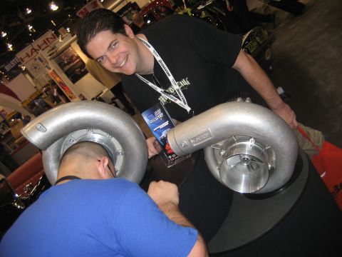 1998 Ford Crown Victoria - Two large turbochargers are displayed, with a man smiling in the background.