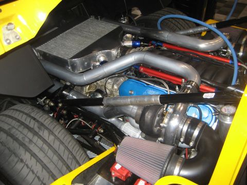 1998 Ford Crown Victoria - Close-up view of a modified engine bay a turbocharger and intercooler system.