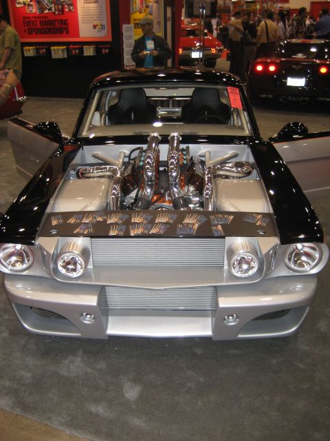 1998 Ford Crown Victoria - Customized classic car with exposed engine and chrome details on display at an event.