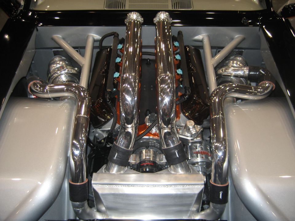Chromed engine with tall velocity stacks and polished headers in silver bay