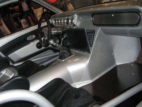 1998 Ford Crown Victoria - The interior of a custom car features a modern dashboard with a laptop and unique gauge cluster.