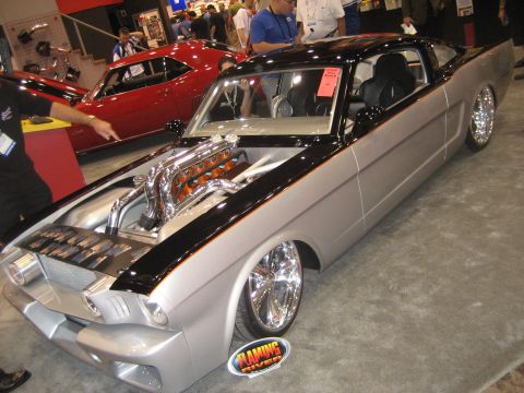 1998 Ford Crown Victoria - Customized 1965 Ford Mustang at a car show, with a red 1969 Camaro visible behind it.
