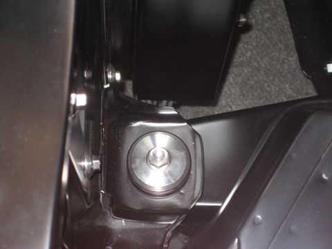 1998 Ford Crown Victoria - Detail of a metal bracket and bolt assembly, likely from a vehicle's interior or undercarriage.