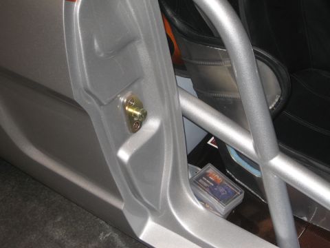 1998 Ford Crown Victoria - Interior view showing the door latch assembly and part of a roll cage.