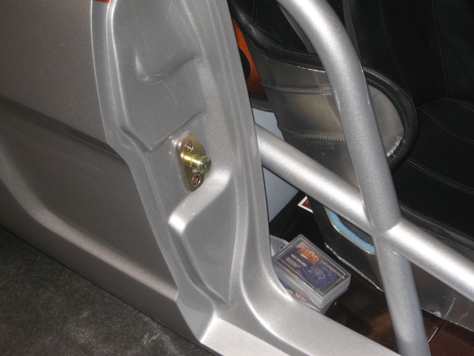 Silver custom door interior with door-pin striker and roll cage bar