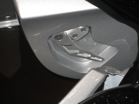 1998 Ford Crown Victoria - Close-up view of a car's door latch mechanism, showing intricate metal parts.