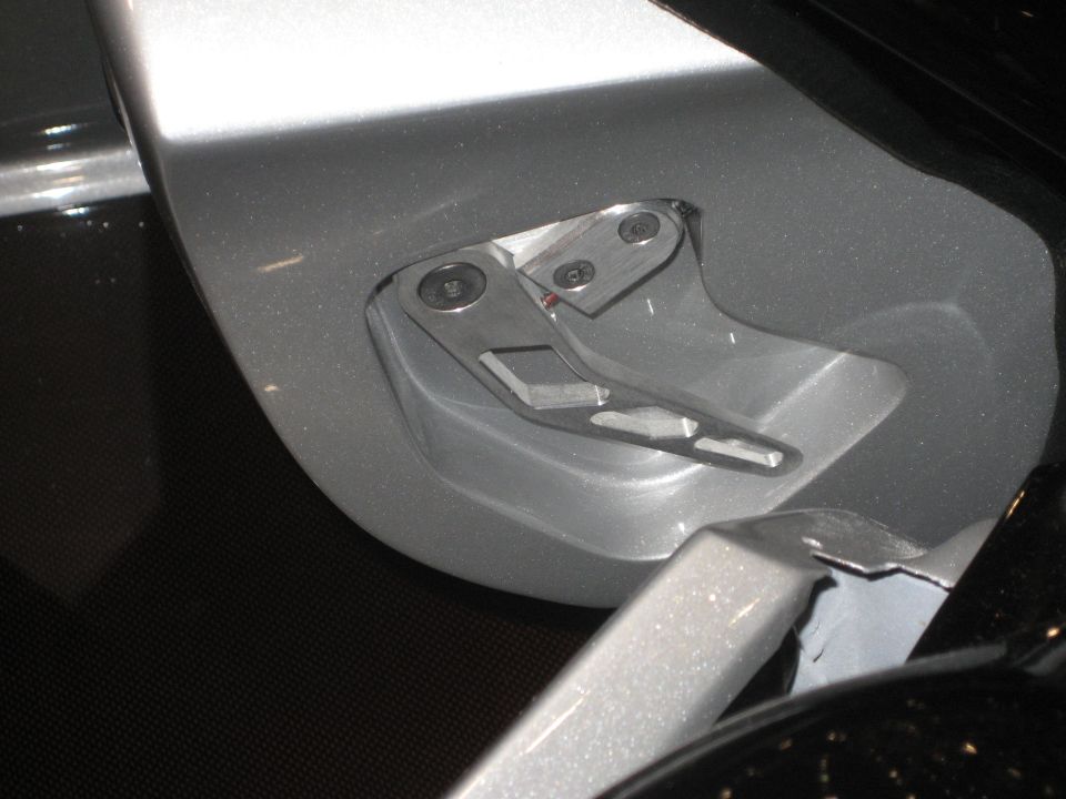 Machined billet hinge mechanism set into silver custom bodywork