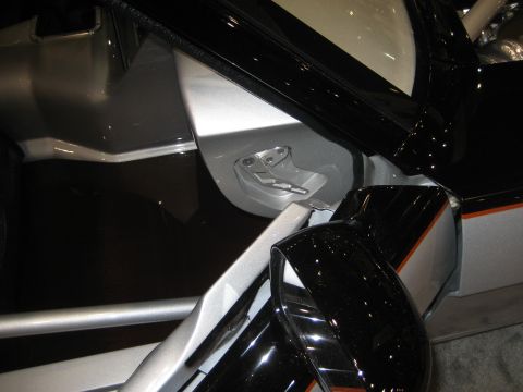 1998 Ford Crown Victoria - Detail of a car's door latch mechanism, revealing the intricate metalwork and contrasting finishes.