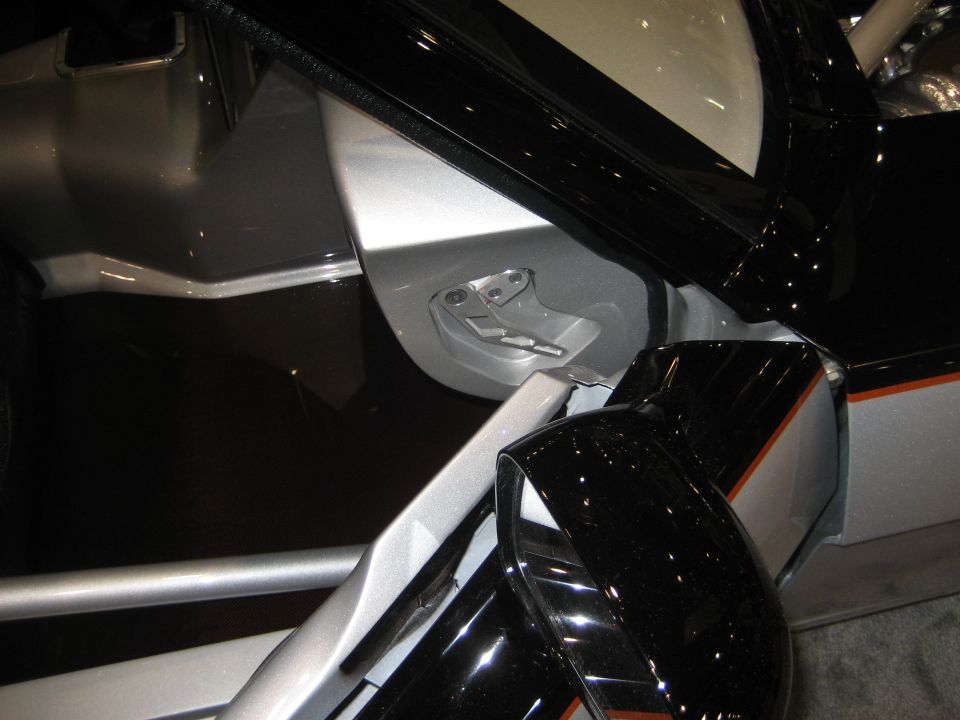 Billet latch mechanism in silver and black custom car body panels