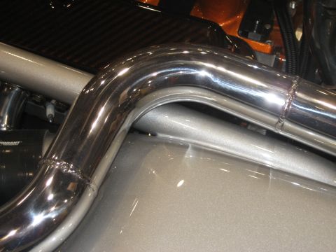 1998 Ford Crown Victoria - Close-up of polished exhaust pipes and engine components, possibly in a custom build.