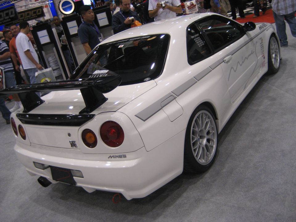 White Nissan Skyline GT-R rear three-quarter with rear wing at car show