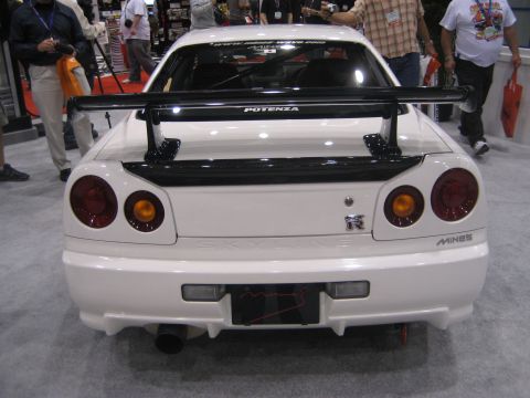 1998 Ford Crown Victoria - Rear view of a white Nissan Skyline GT-R with a prominent spoiler and aftermarket exhaust.