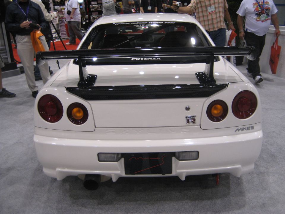 Rear view of white Nissan Skyline GT-R with carbon Potenza wing