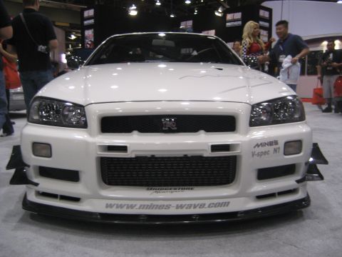1998 Ford Crown Victoria - Front view of a white sports car, possibly a Nissan Skyline GT-R, with custom aerodynamic modifications and branding.