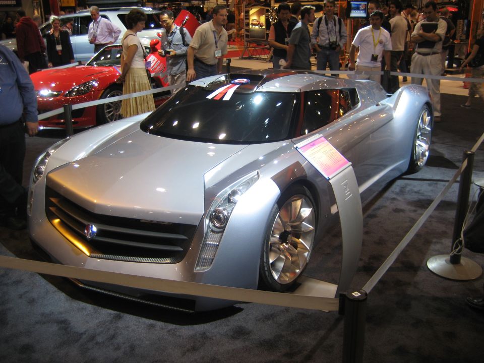 Silver Cadillac concept supercar with red and white roof stripe at a show