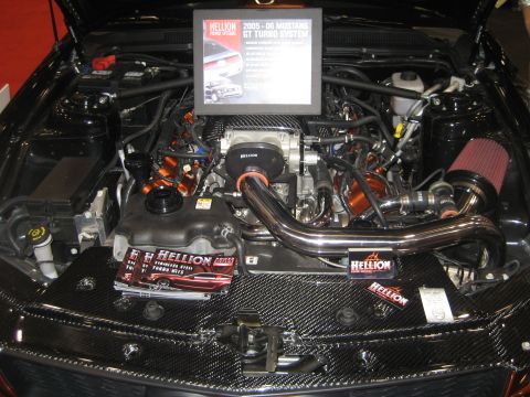 1998 Ford Crown Victoria - Engine bay a Hellion 2005-06 Mustang GT Turbo System with custom orange accents and carbon fiber trim.