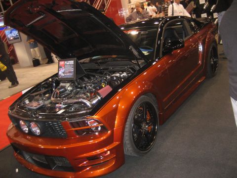 1998 Ford Crown Victoria - Customized Ford Mustang on display with its engine exposed.