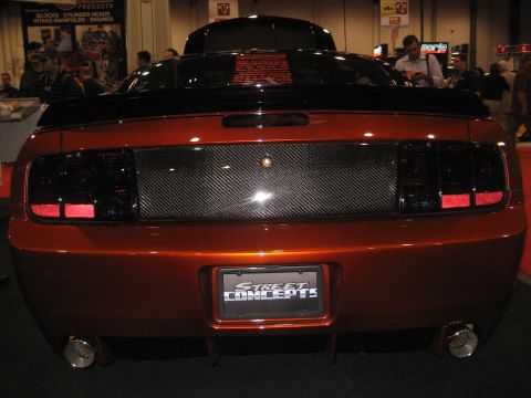 1998 Ford Crown Victoria - This custom orange car features a carbon fiber rear panel and a license plate frame that reads STREET CONCEPTS.