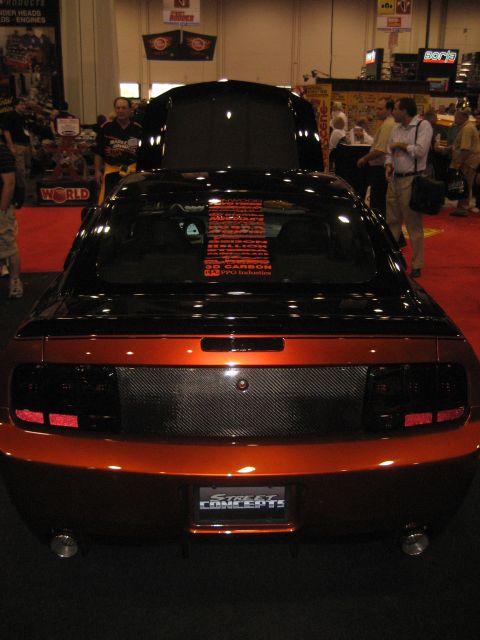 1998 Ford Crown Victoria - Rear view of a customized Ford Mustang with a carbon fiber panel and custom paint.