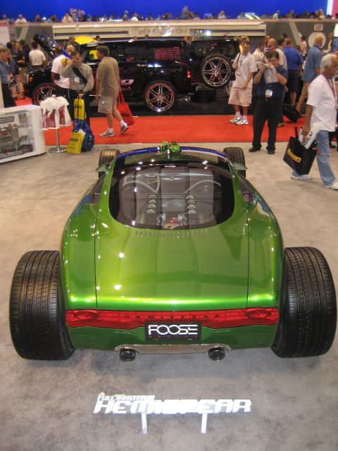 1998 Ford Crown Victoria - This custom hot rod, identified by "FOOSE" badging, features a striking green paint job and a visible engine through the rear window.