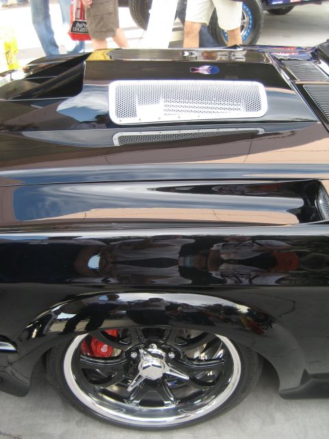 1998 Ford Crown Victoria - Custom car fender and wheel detail with chrome accents and red brake caliper visible.