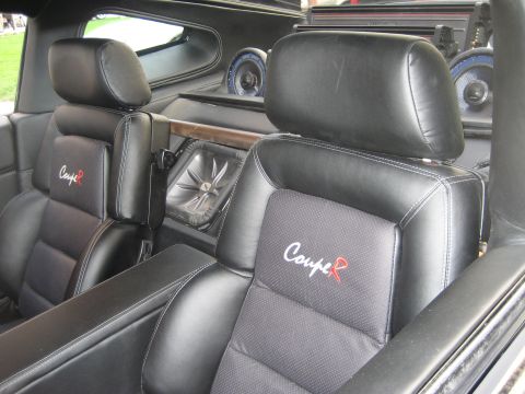 1998 Ford Crown Victoria - Interior view of a car with custom black leather seats and aftermarket audio system.