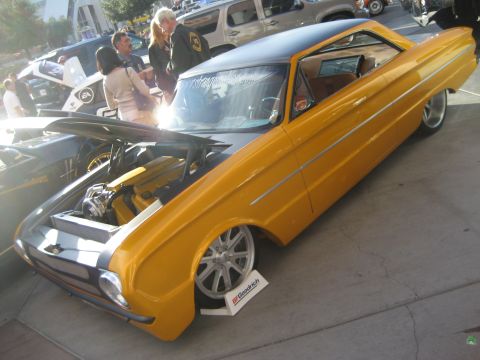 1998 Ford Crown Victoria - A yellow classic car is displayed with its hood open, revealing a custom engine and modifications.
