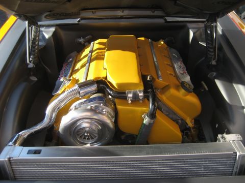 1998 Ford Crown Victoria - Custom engine bay with a bright yellow engine and polished turbocharger.