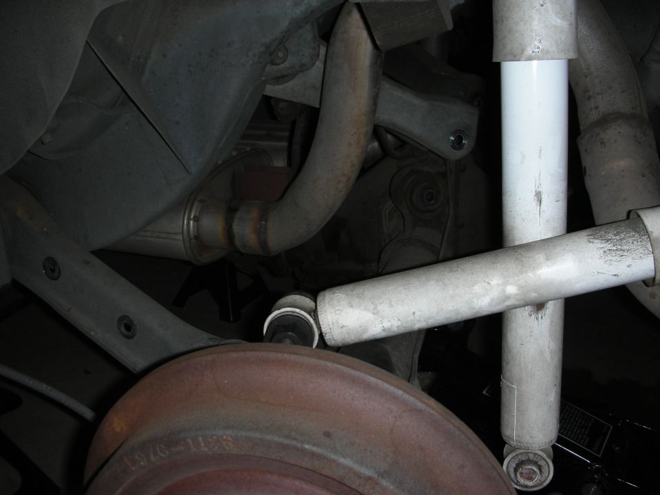 Rear suspension components including shock absorber and brake drum