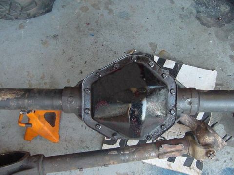 1971 Ford Bronco - A differential axle assembly is shown, with a black cover and part of a drive shaft visible.